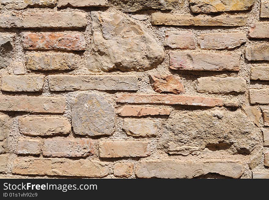 Rough medieval wall with bricks and stones. Rough medieval wall with bricks and stones.