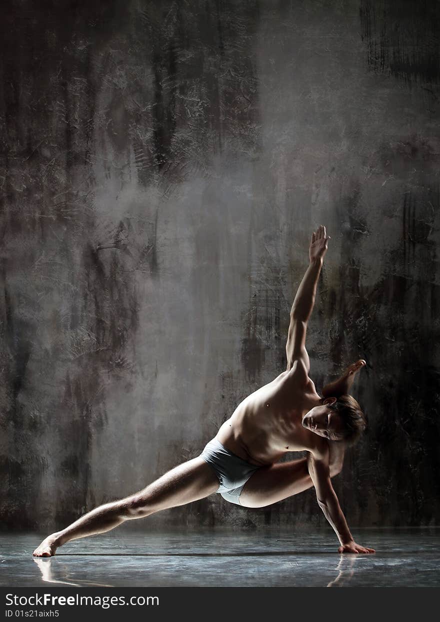 Cool yoga man posing on dirty grunge background. Cool yoga man posing on dirty grunge background