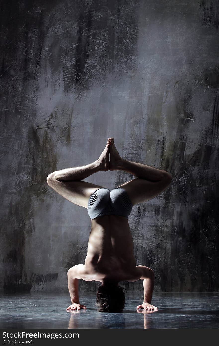 Cool yoga man posing on dirty grunge background. Cool yoga man posing on dirty grunge background