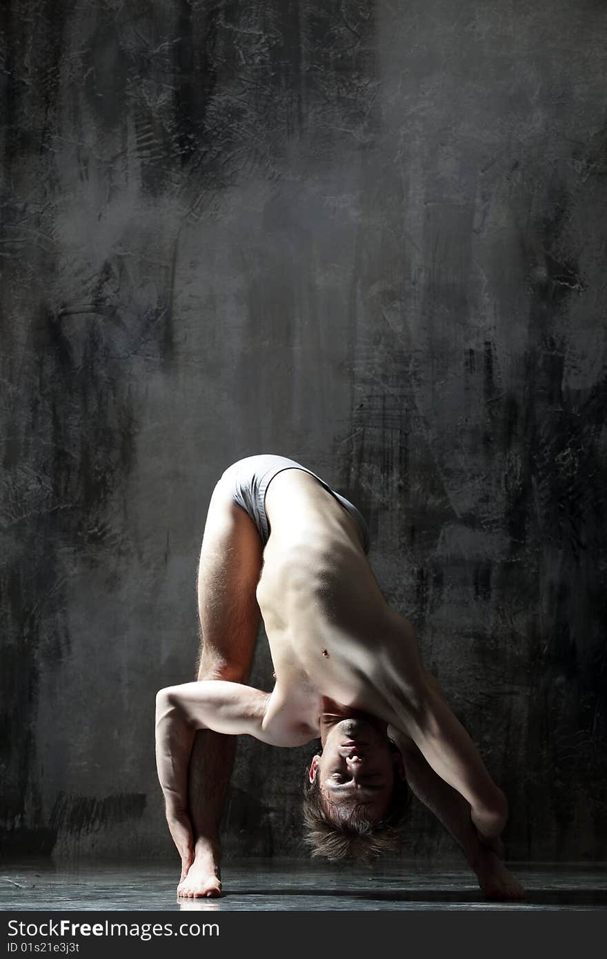 Cool yoga man posing on dirty grunge background. Cool yoga man posing on dirty grunge background