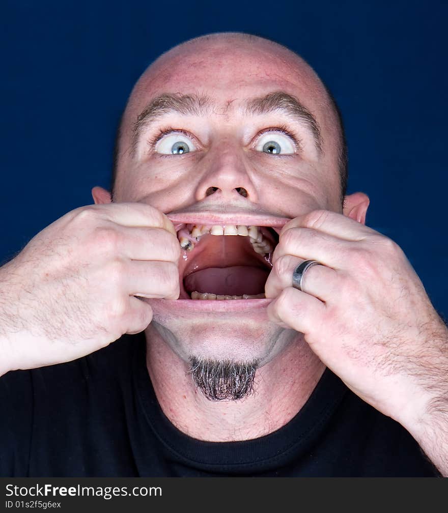 Caucasian mid adult man with hands in mauth making scared facial expression,studio shot. Caucasian mid adult man with hands in mauth making scared facial expression,studio shot