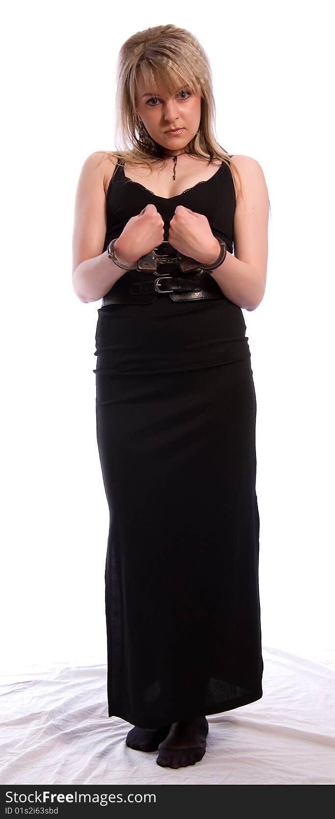 Young woman in handcuffs. Studio shoot on white background. Young woman in handcuffs. Studio shoot on white background