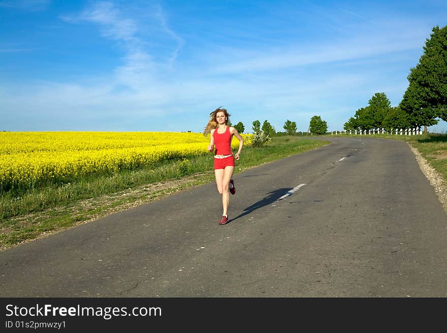 An image of a girl running on the road. An image of a girl running on the road