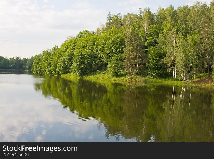 Picturesque landscape spring river and bright trees and bushes, against the backdrop of skies. Picturesque landscape spring river and bright trees and bushes, against the backdrop of skies.