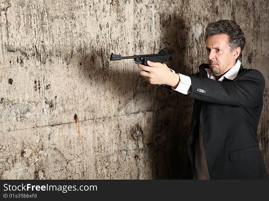 Man killer with gun on dark background