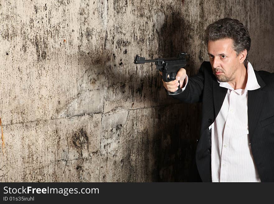 Man killer  with gun on dark background