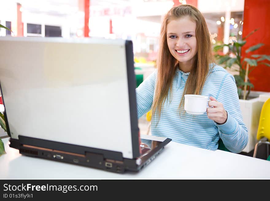 Young woman with laptop and coffee