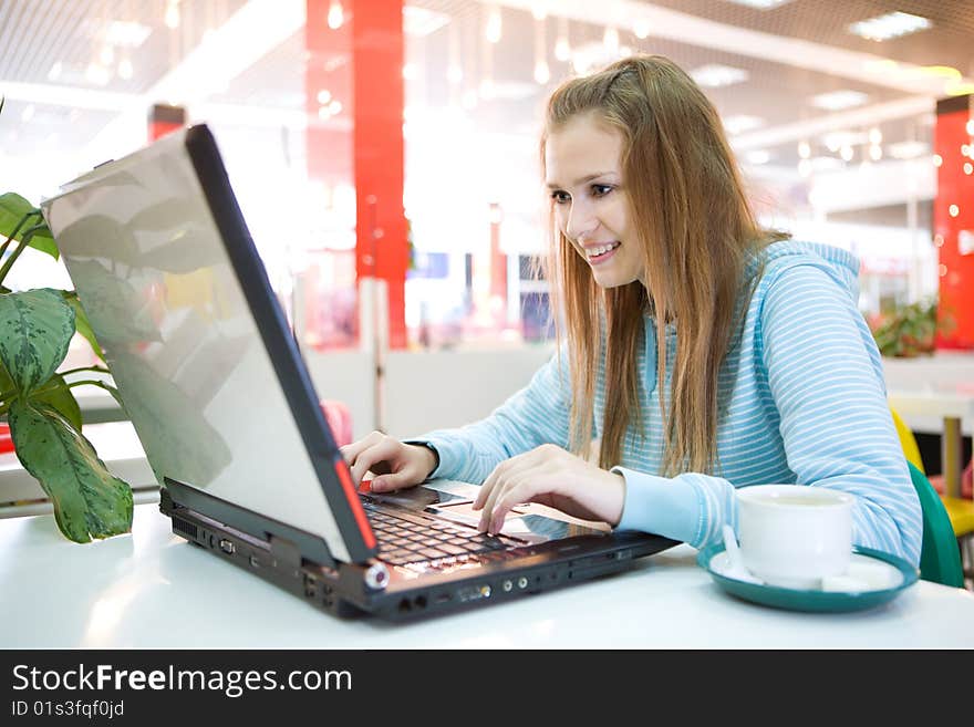 Young woman with laptop and coffee