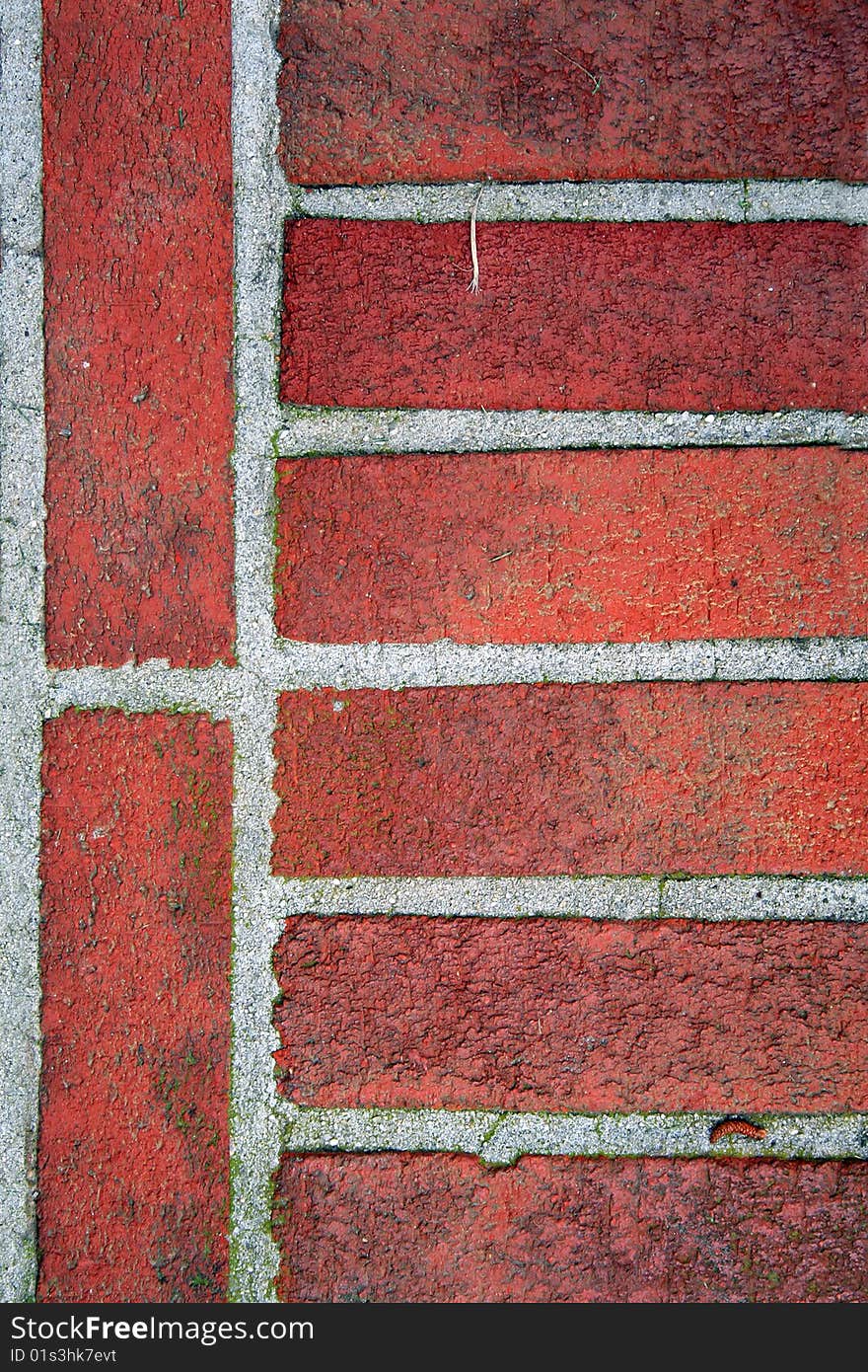 Dirty worn red bricks with moss. Dirty worn red bricks with moss