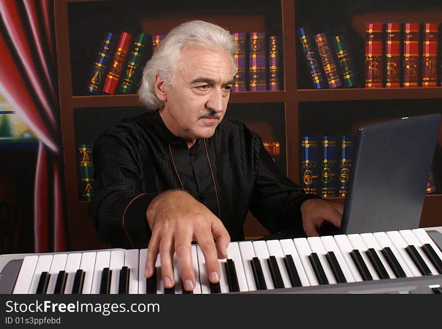 Pianist man in black with piano. Pianist man in black with piano