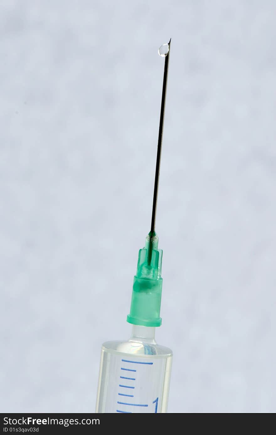 Syringe with needle ready for injection on a light background. Syringe with needle ready for injection on a light background