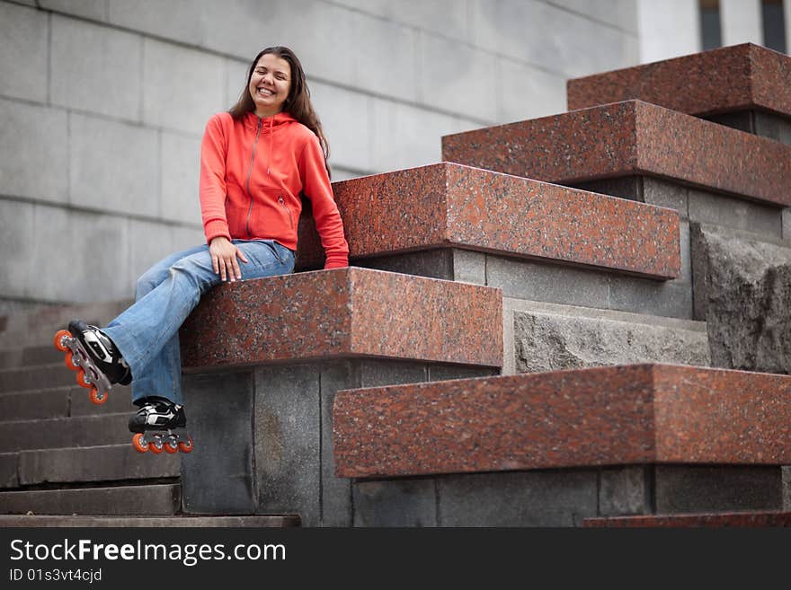 Portrait of rollerskating girl on granite stairs - shallow DOF