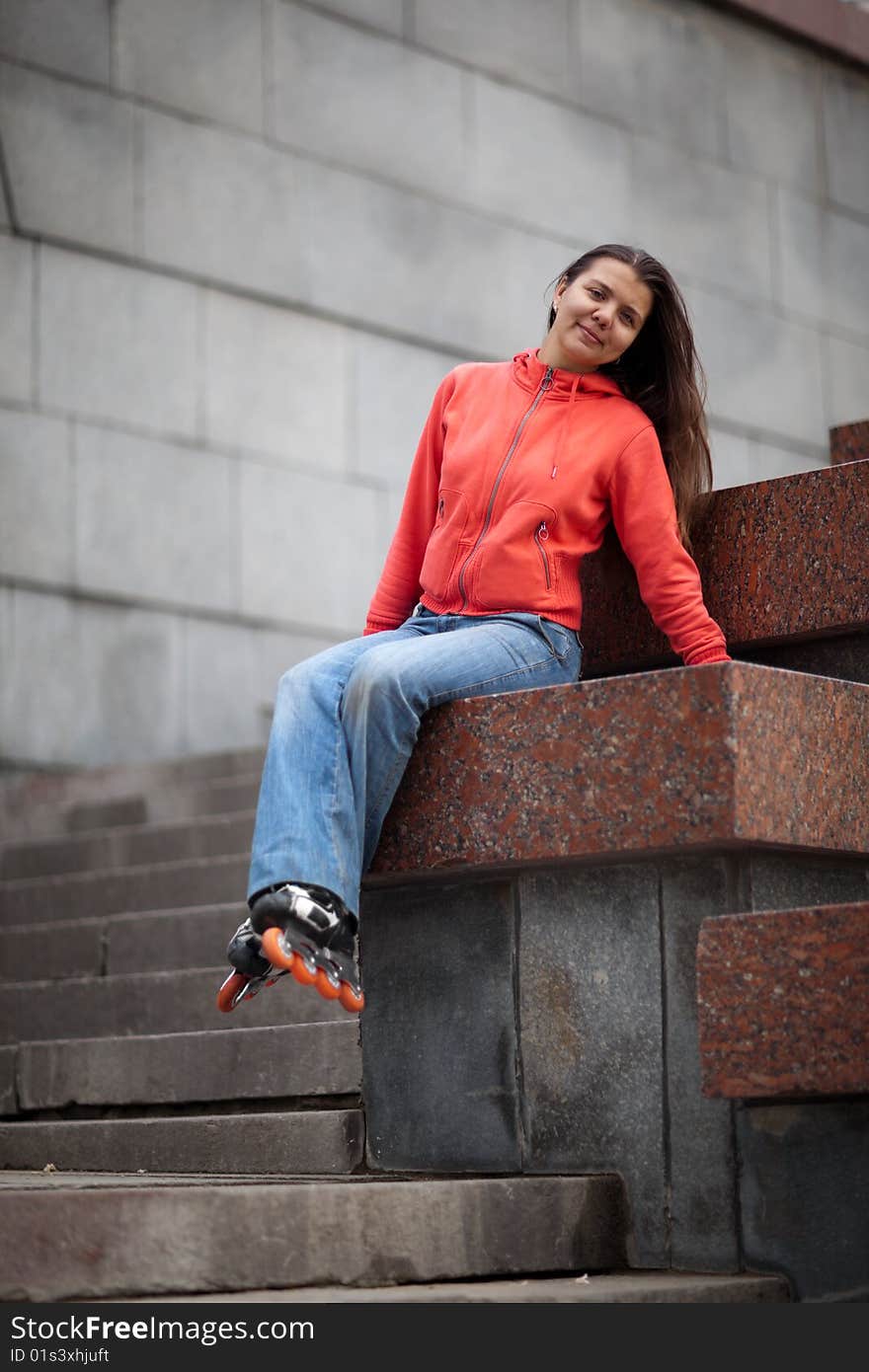 Portrait of rollerskating girl on granite stairs - shallow DOF