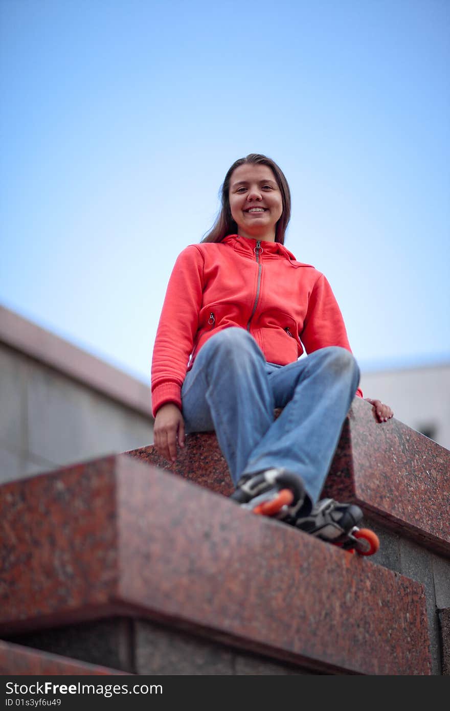 Portrait of rollerskating girl on granite stairs - shallow DOF