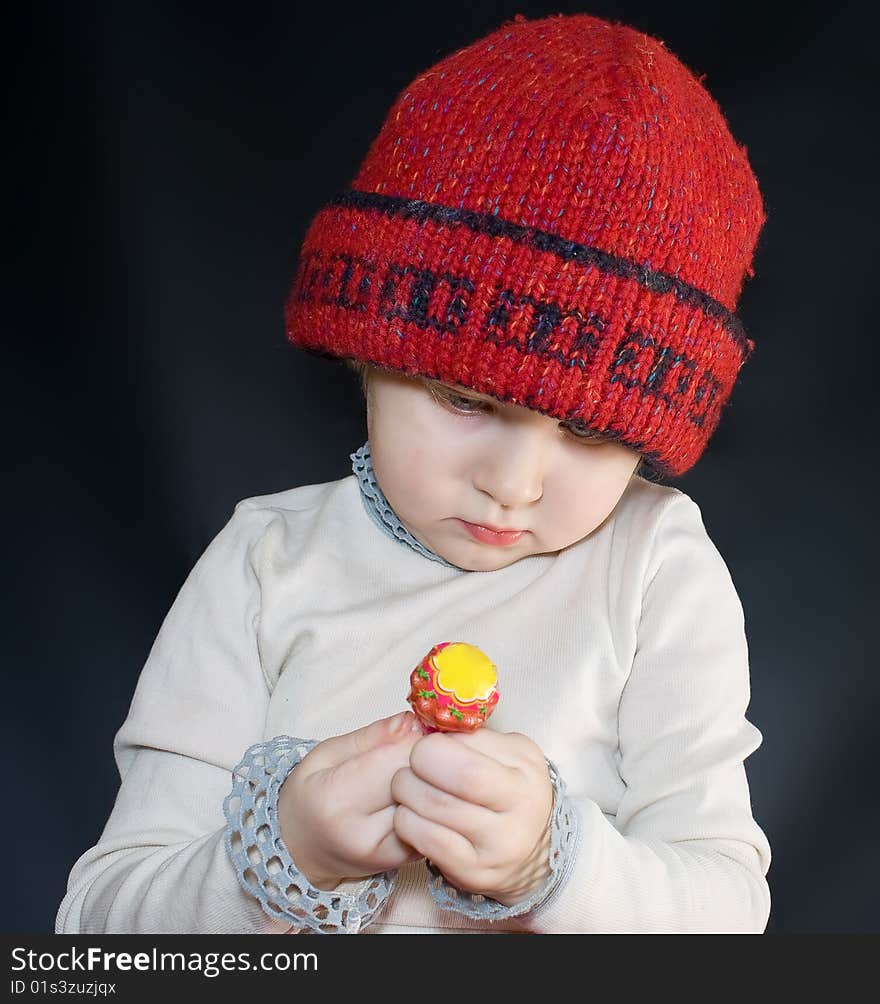 Girl looks at a candy on a stick. Girl looks at a candy on a stick