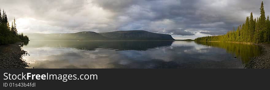 Panorama of a sunlitted foggy lake. Panorama of a sunlitted foggy lake