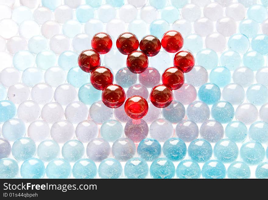 Red glass heart on blue background. Red glass heart on blue background