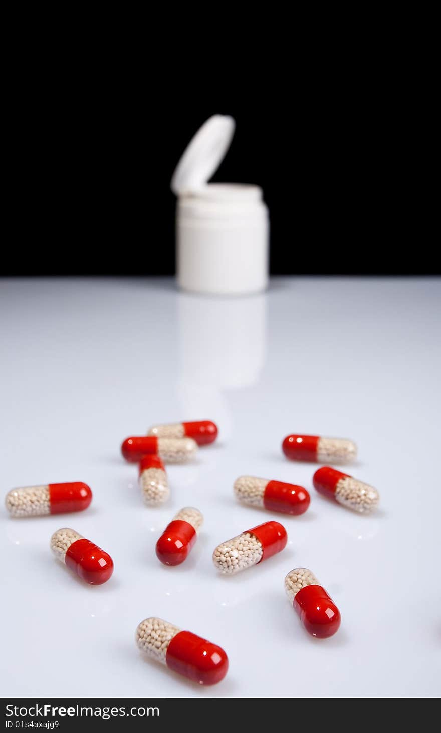 Tablets and a jar on a light blue background. Tablets and a jar on a light blue background