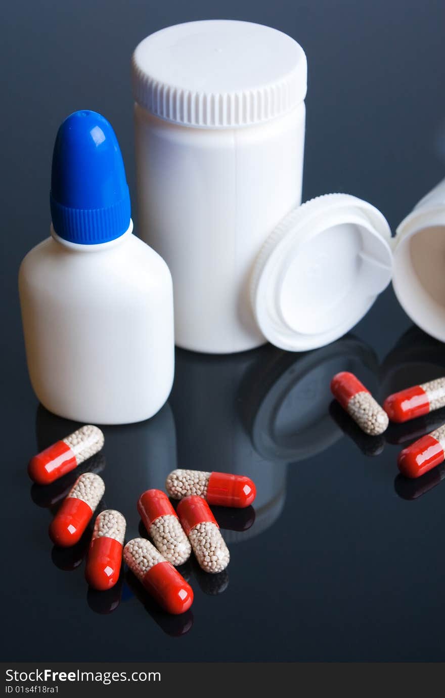 Tablets and jars against a dark background. Tablets and jars against a dark background