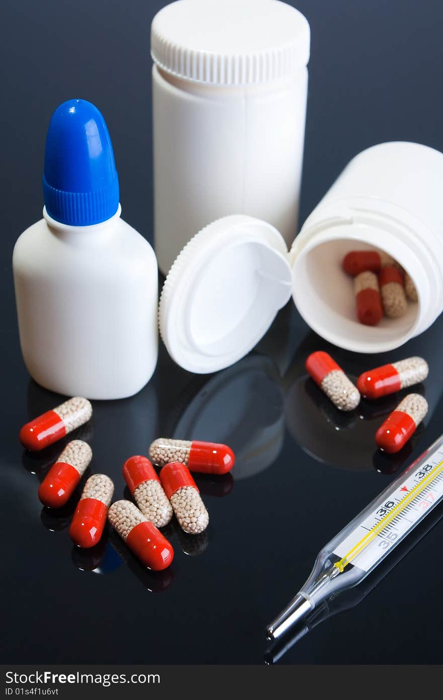 Tablets and jars against a dark background. Tablets and jars against a dark background