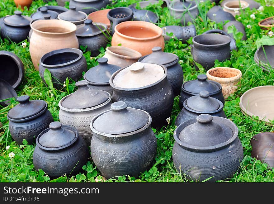 Antique clay pots on green grass