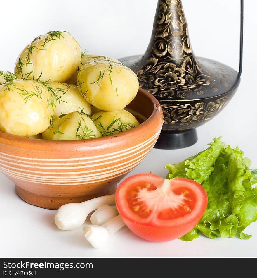 An image of potatoes, onions, lettuce and tomato. An image of potatoes, onions, lettuce and tomato