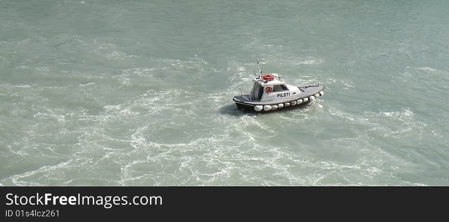 A pilot boat guiding way out of ferry in ancon port