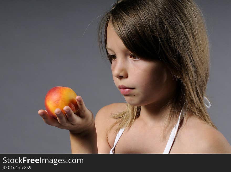 Portrait of cute girl with tasty peach. Portrait of cute girl with tasty peach