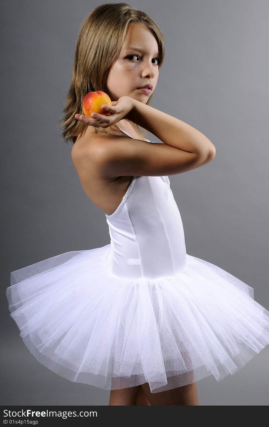 Portrait of beautiful ballerina with tasty peach. Portrait of beautiful ballerina with tasty peach