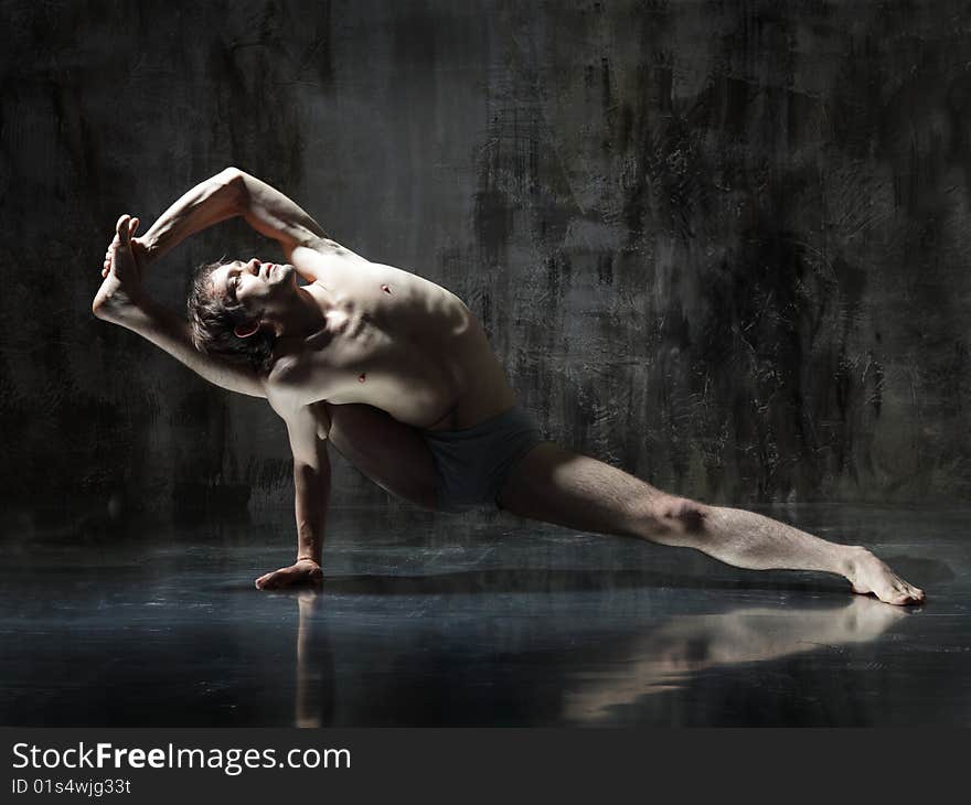 Cool yoga man posing on dirty grunge background. Cool yoga man posing on dirty grunge background