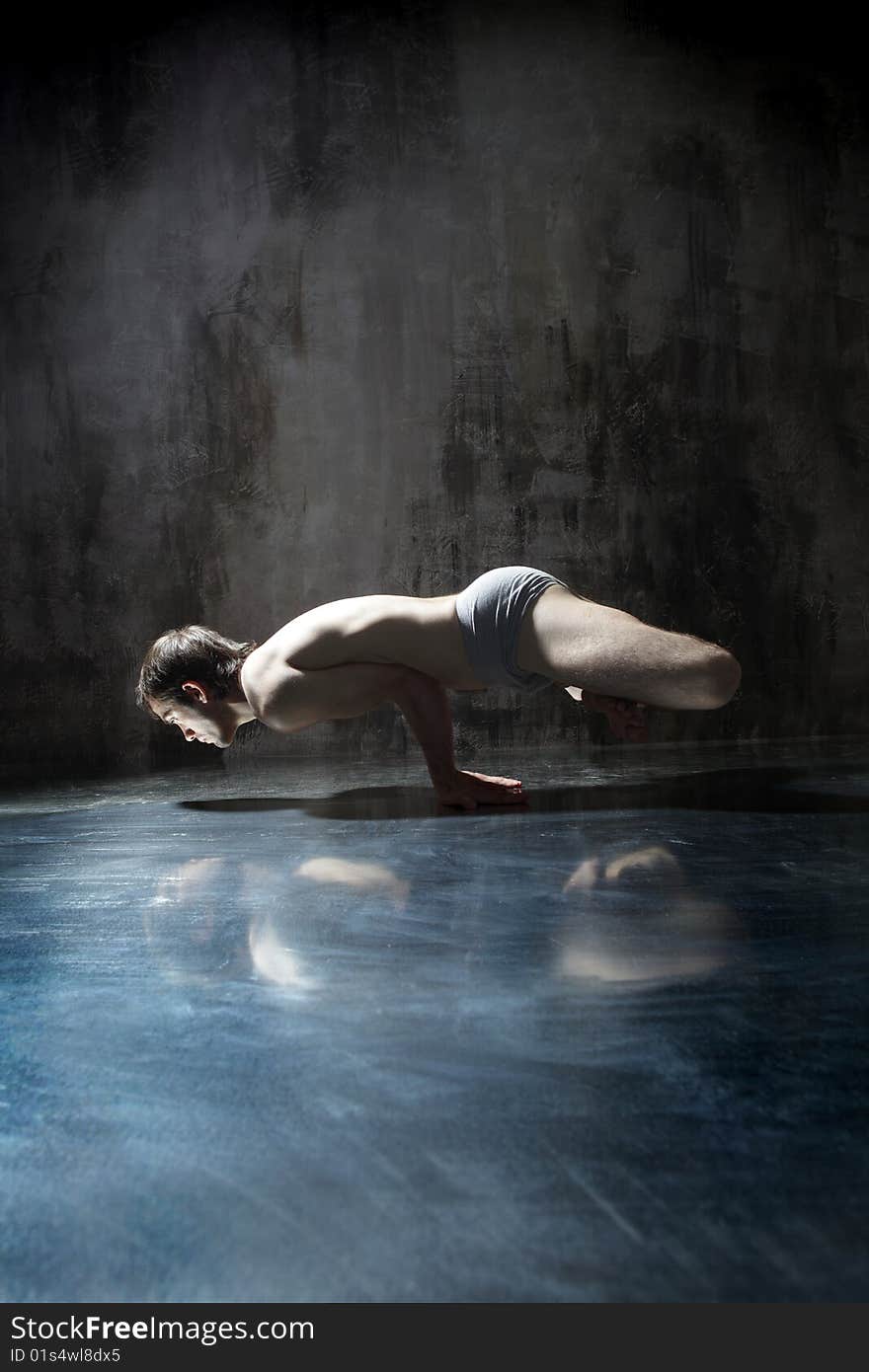 Cool yoga man posing on dirty grunge background. Cool yoga man posing on dirty grunge background