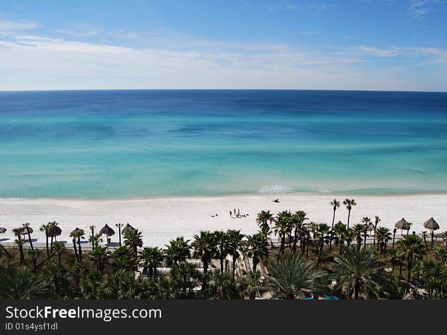 View of the clear blue water and beaches from a beachfront hotel.