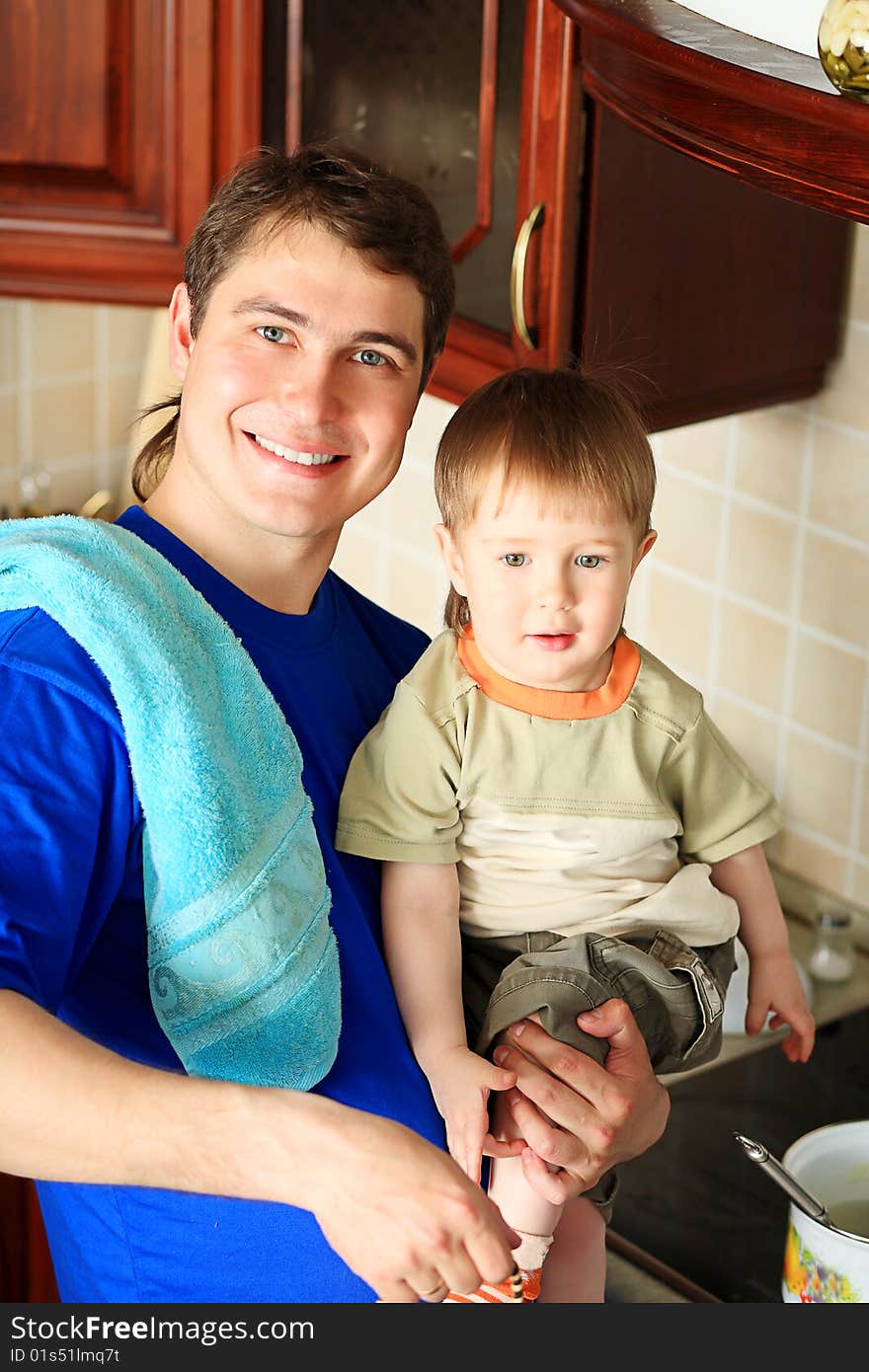 Happy father with his son on a kitchen at home. Happy father with his son on a kitchen at home.