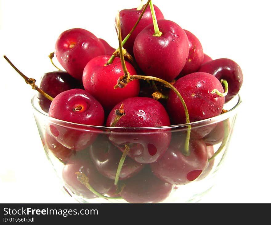 A bowl of fresh cherries on a white background. A bowl of fresh cherries on a white background