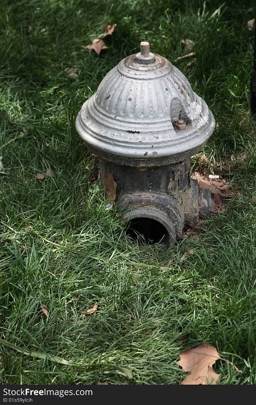 Hydrant gray fireplug pipe grass street emergency water. Hydrant gray fireplug pipe grass street emergency water