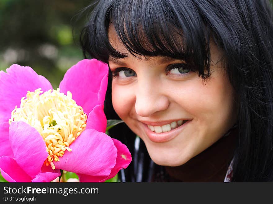 Portrait of the young nice girl with a flower. Portrait of the young nice girl with a flower