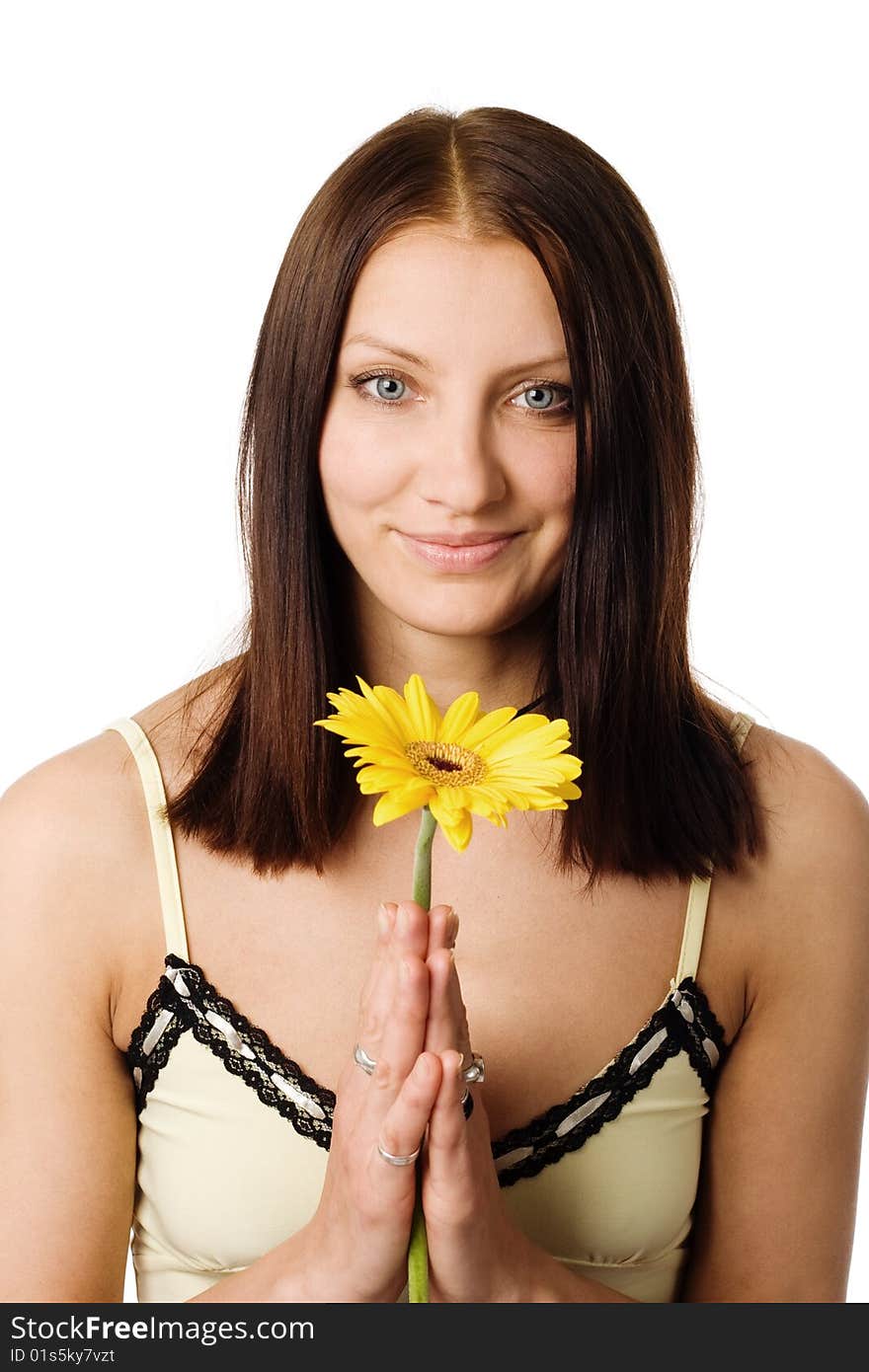 A nice girl with a yellow flower in her hands. A nice girl with a yellow flower in her hands