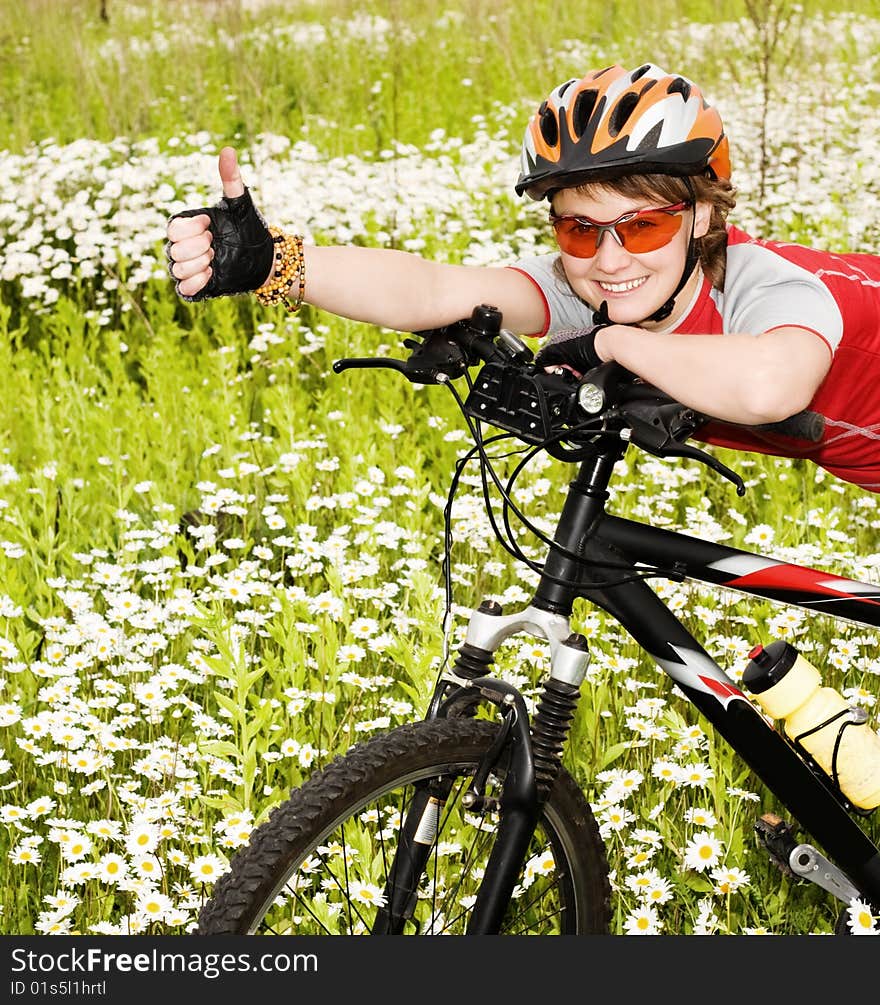 An image of a girl with a bicycle in the field. An image of a girl with a bicycle in the field