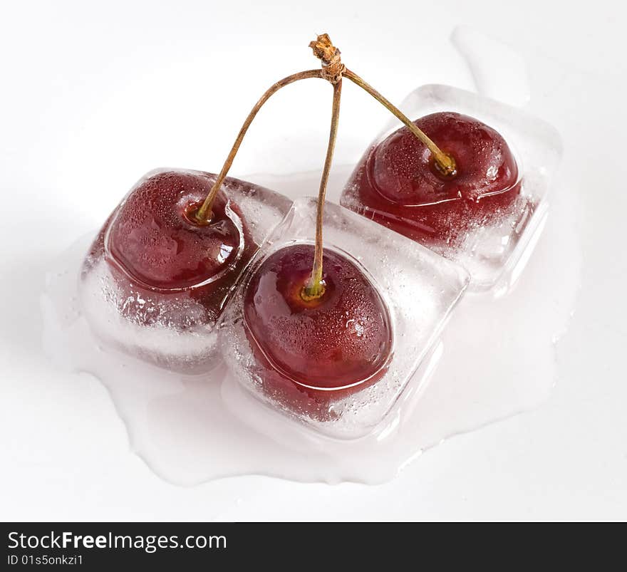 Group of cherries, frozen inside ice cubes, melting. Group of cherries, frozen inside ice cubes, melting.