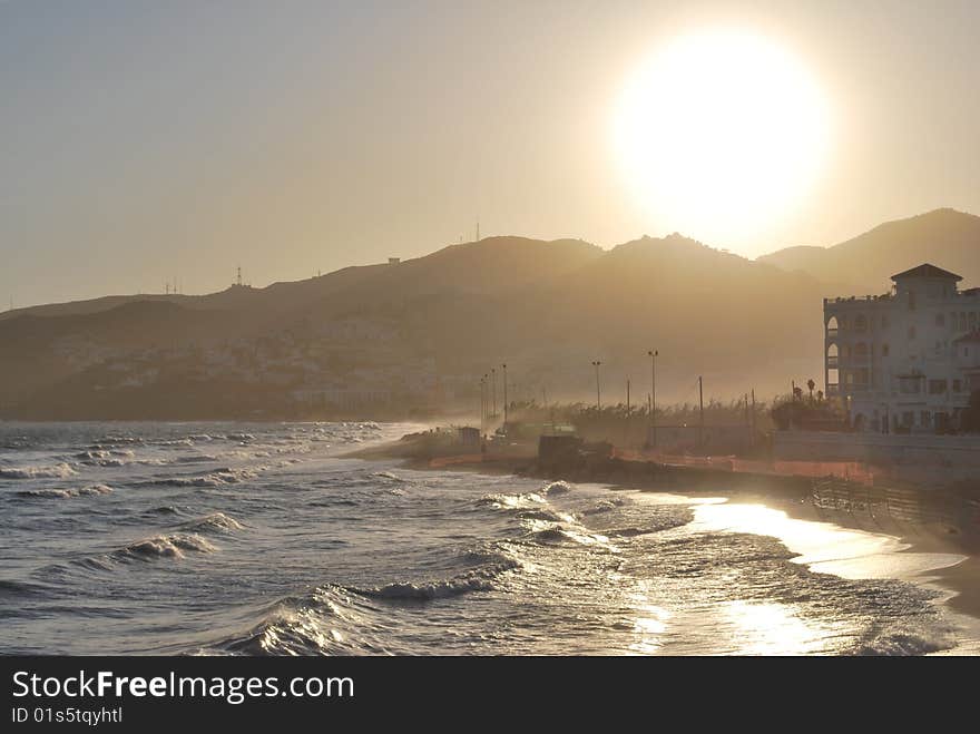 Sun setting over mountains and ocean. Sun setting over mountains and ocean