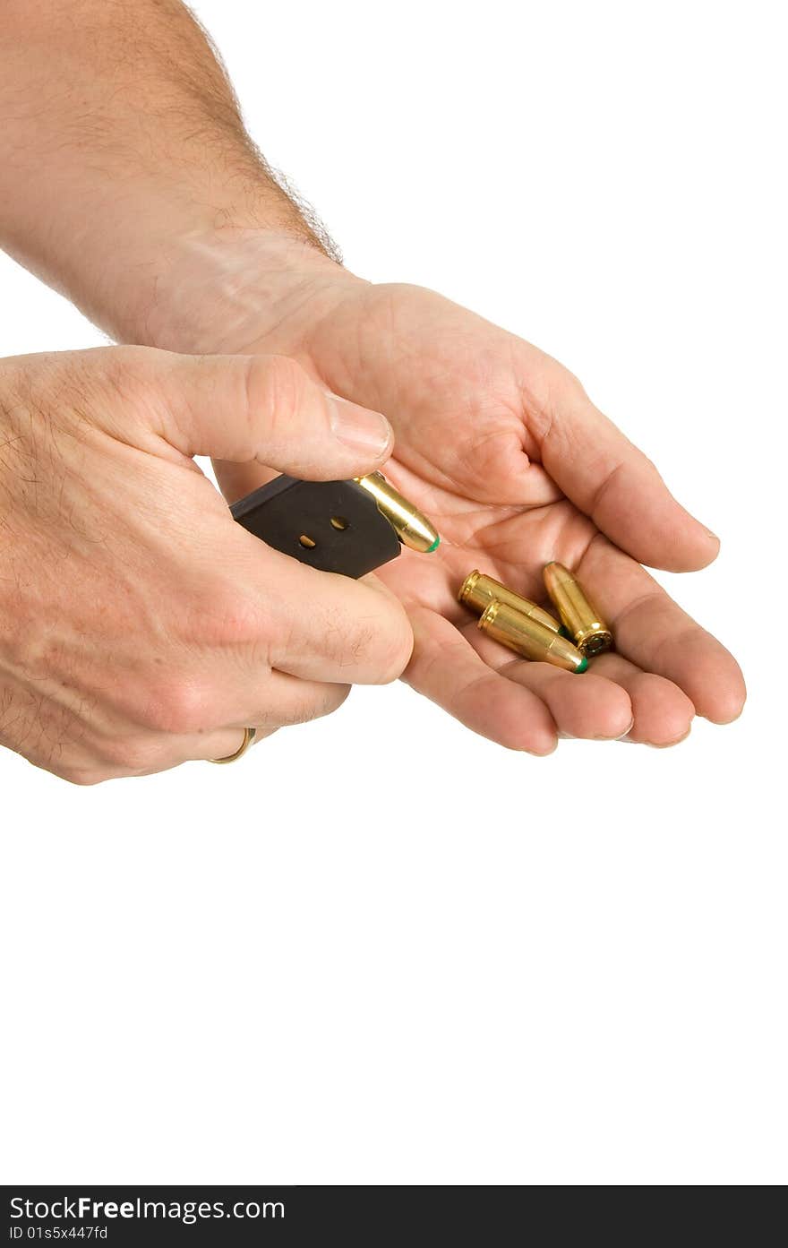 Bullets flying out of a bulletholder in a male hand on white