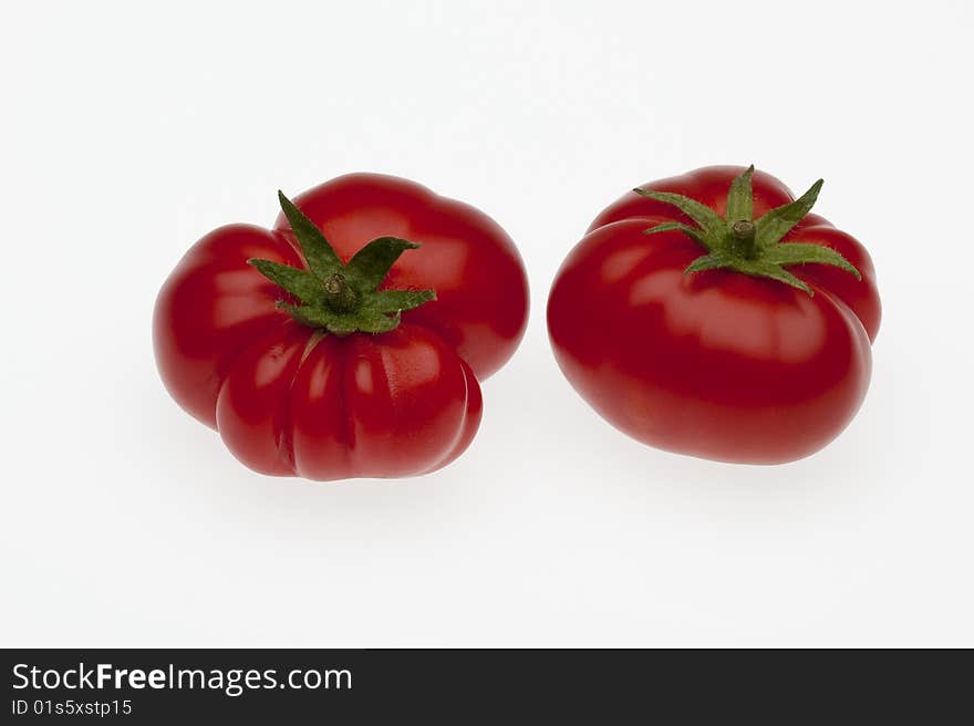 Two biologically cultivated tomatoes, small size with hand made clipping path. Two biologically cultivated tomatoes, small size with hand made clipping path