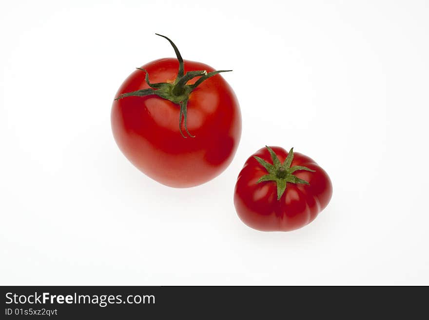 Two tomatoes one from biological culture and one from regular trade. Two tomatoes one from biological culture and one from regular trade