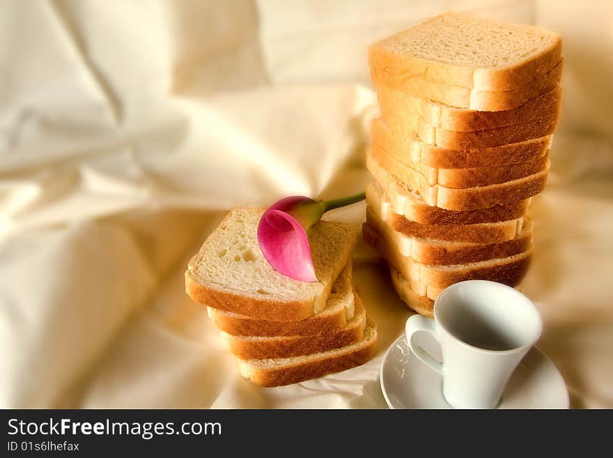 Coffe bread and flower in a white background