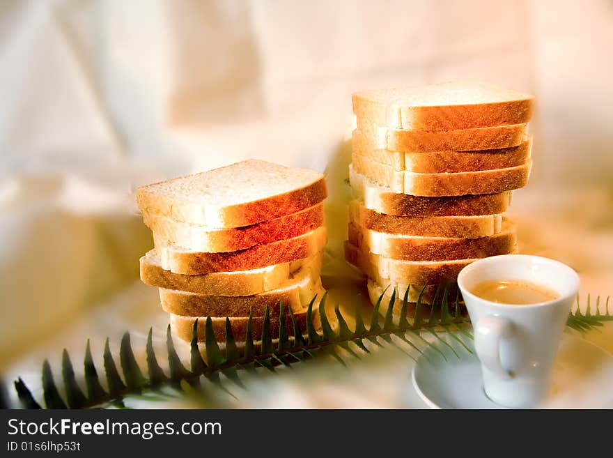 Coffe and bread in a white background