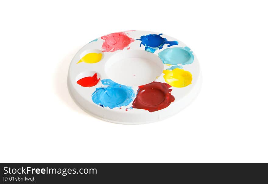 Round kids' palette with colorful paints isolated. Round kids' palette with colorful paints isolated