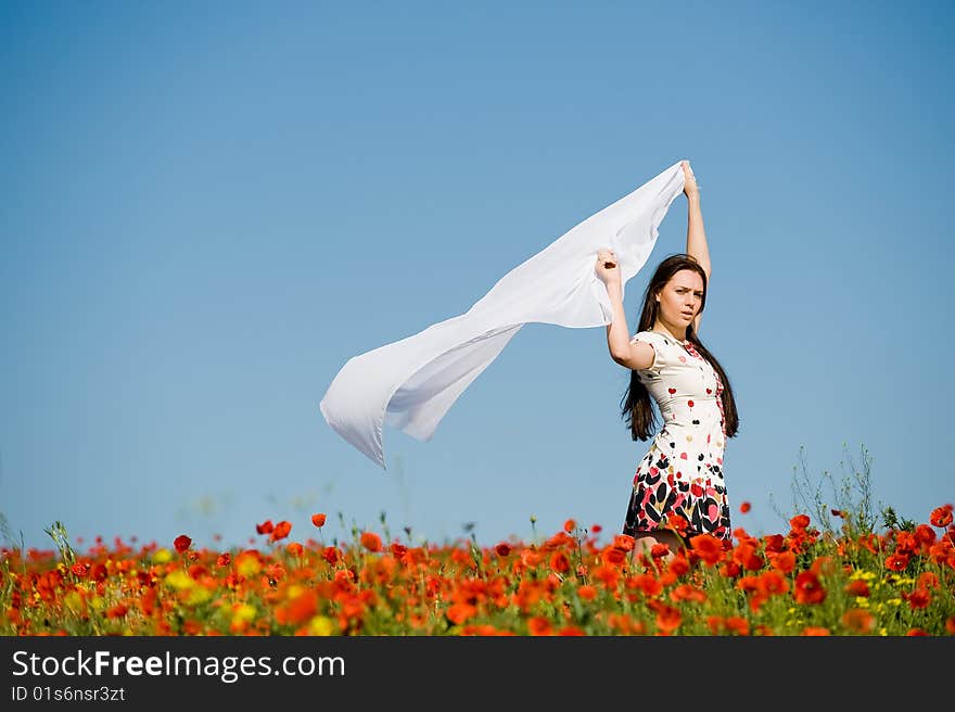 Beautiful girl with white scarf in the poppy field. Beautiful girl with white scarf in the poppy field