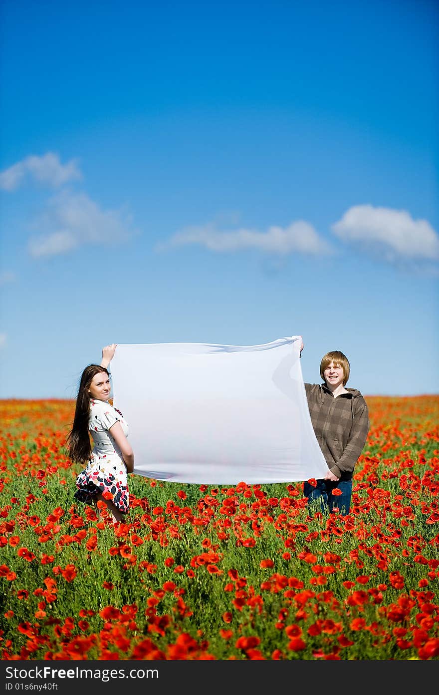 Lovely couple in the poppy field, copy-space for your text