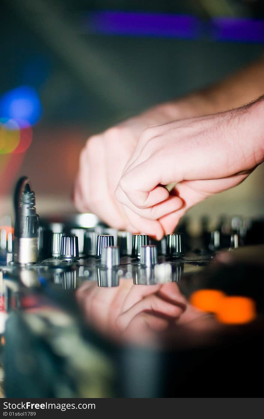 Close-up of deejays hand and turntable, soft focus