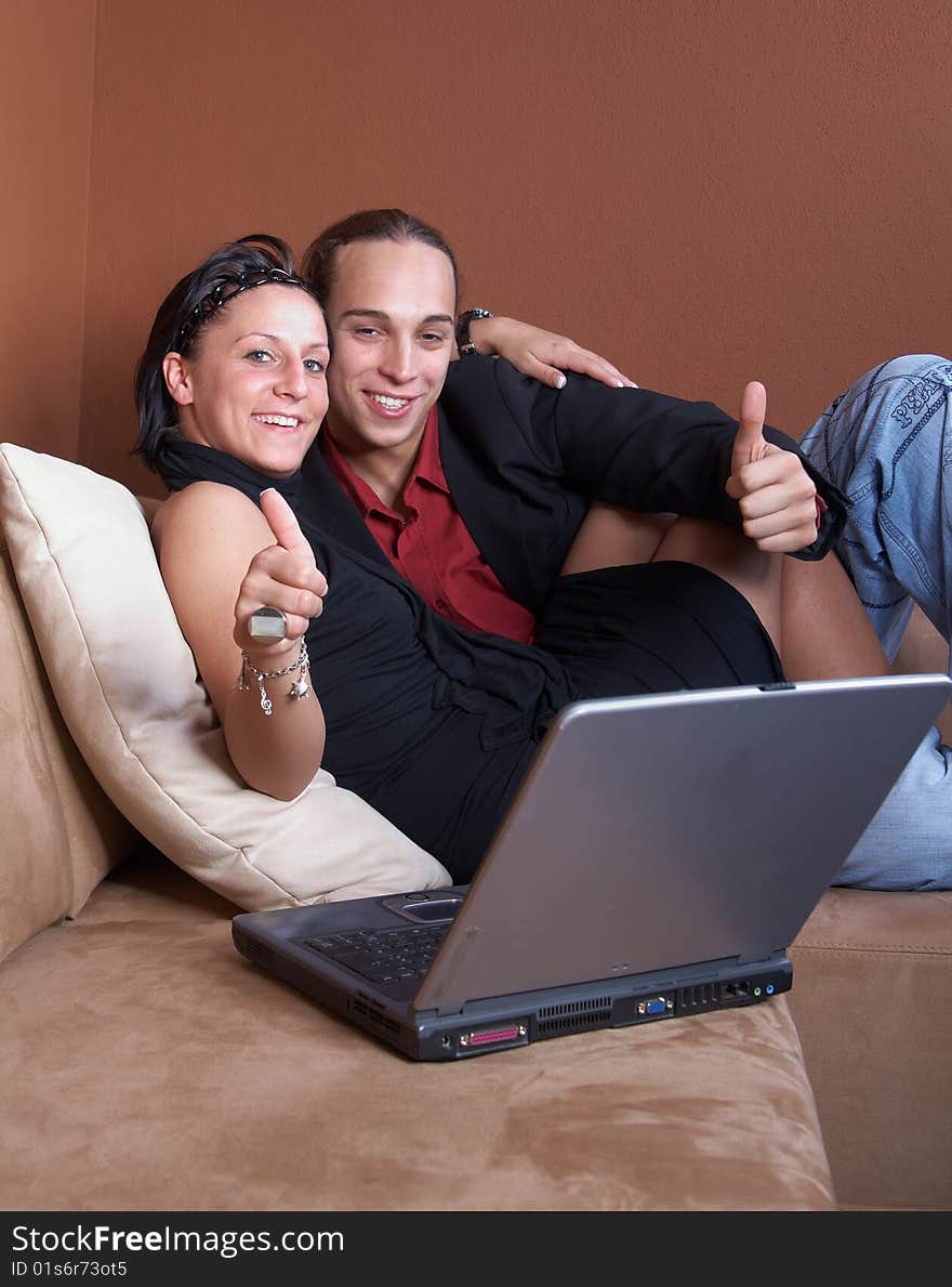 Young couple on the couch surfing the web with their laptop. Young couple on the couch surfing the web with their laptop.